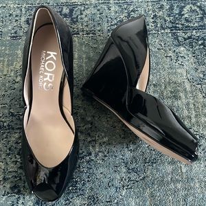 These size 8 Michael Kors black Patten leather 3 1/2” wedges are so comfy fancy